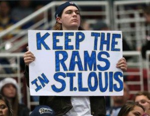 A Rams fan holds a sign at a game in 2014 calling for the Rams to stay in St. Louis. 