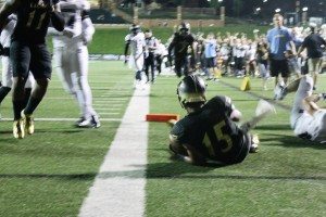 Jessie Scroggins dives across the goal line against Washburn. 