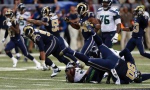 The Rams defensive line starts to celebrate after tackling Marshawn Lynch in the backfield to end the game.