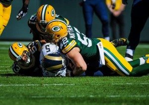 Nick Foles being sacked by a trio of Packers. Photo via Getty Images.