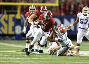 Derrick Henry evades a Florida defender. Photo via Kent Gidley.