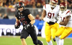 Stanford's Christian McCaffrey runs by USC during the Pac-12 title game. Photo via Kirby Lee/USA TODAY Sports.