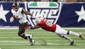 BGSU's Ronnie Moore stiff arms a diving Northern Illinois defender. Photo via BGSU Marketing and Communications.